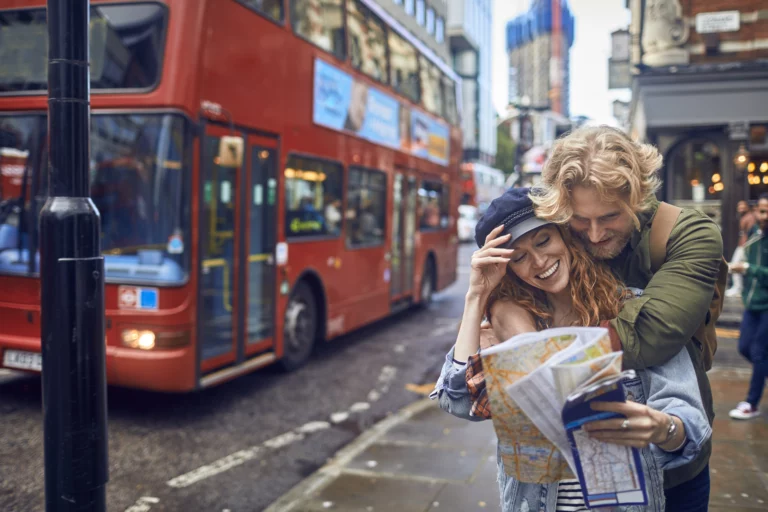 A young couple with a street plan on a City Trip in London